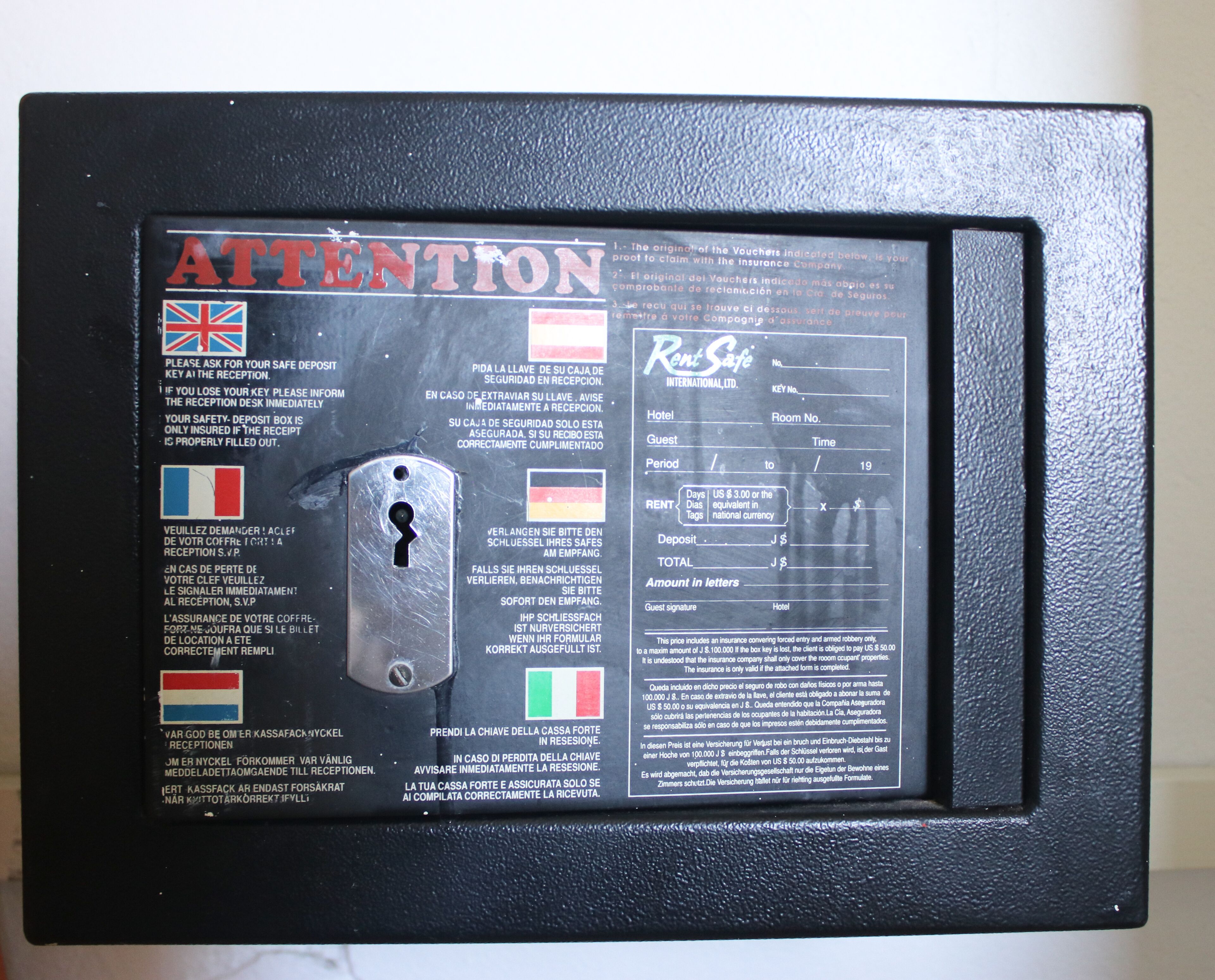 A black metal frame with a glass panel displaying text and a keyhole.