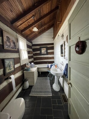 Bathtub, towels, soap, toilet paper