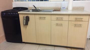 Een oven, een koffiezetapparaat/waterkoker, een kinderstoel