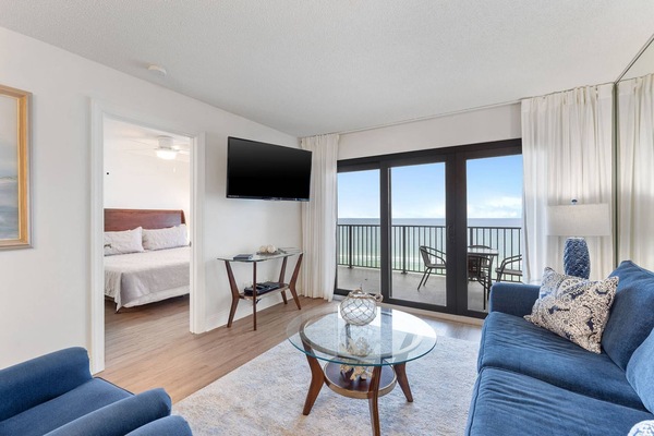 This well-furnished living room with a stunning view of the gulf creates a relaxing and inviting atmosphere.