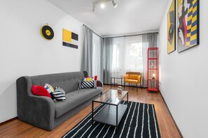 Apartment | Living area | 32-inch flat-screen TV with cable channels, TV - Sleepway Apartments - Garbary 95-101d (Poznan)