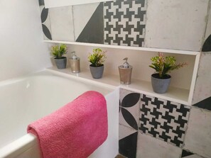 Bathtub, hair dryer, towels, soap