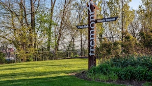 A wooden signpost with directions to Historic Tremont and Clark Field. - Tremont - 2BR apt - Pet Friendly, Convenient to Stadiums, Clinic, Museums & more (Cleveland)