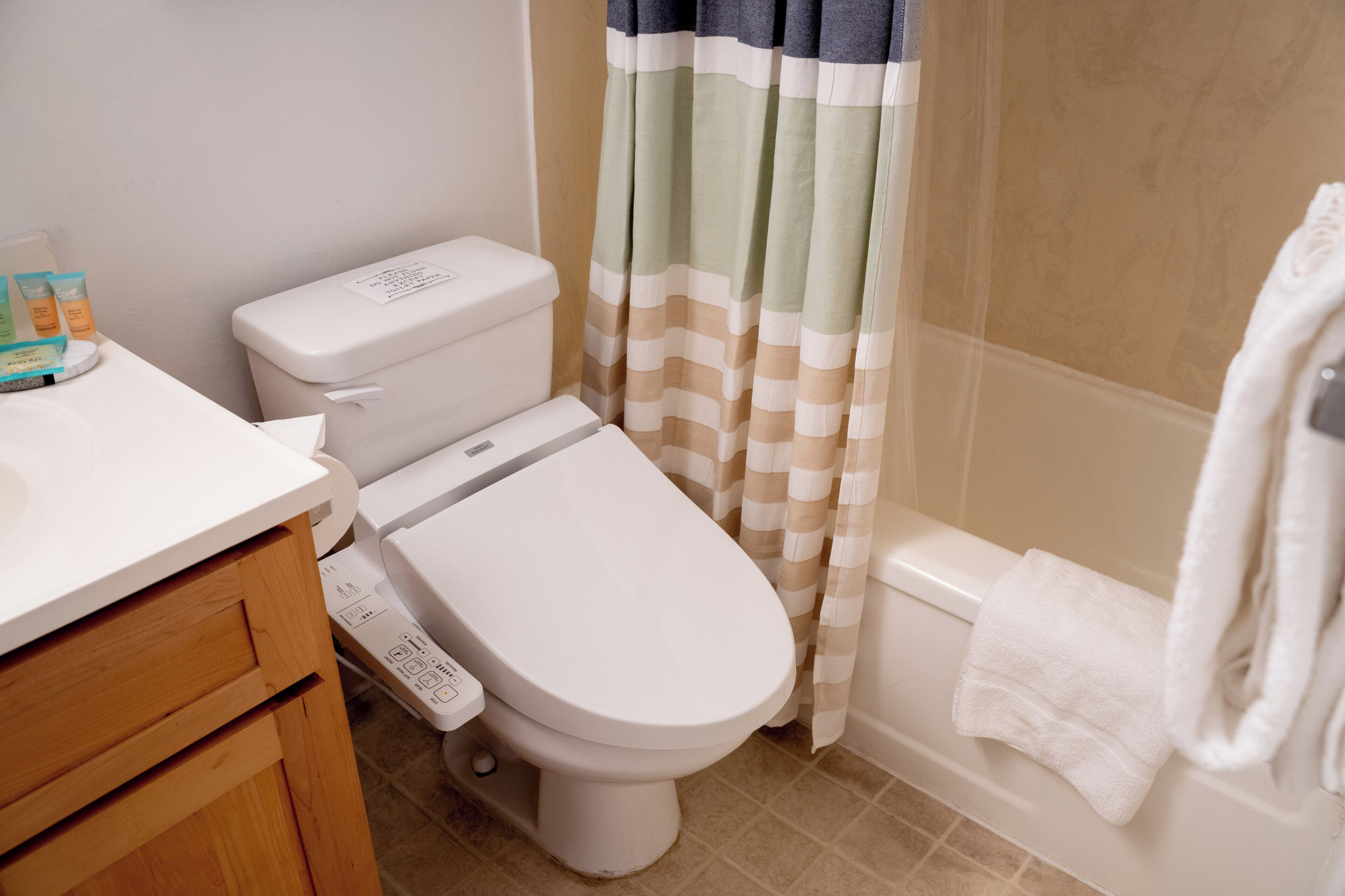 A bathroom with a toilet, a sink, and a bathtub.