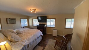 A bedroom with a bed, a chair, a TV, and a heater. - Beautiful Country Home on 11 Acres Near Toledo Bend Lake. (Milam)