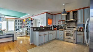 A spacious kitchen with a central island, built-in bookshelves, and a large window. - 2 Bedroom/2 Bathroom Stylish Designer Flat (San Francisco)