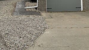 A two-story house with a garage, a satellite dish, and a covered grill area. - JC's Place #1 (Hebron)