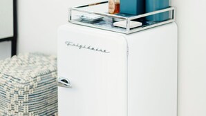 A compact, white refrigerator with a built-in coffee maker and a small storage compartment.