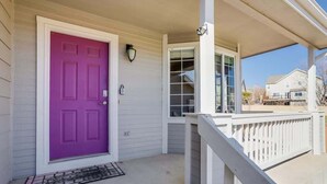 A house with a purple door, a white porch, and a mailbox. - 2 Master Suites with King beds fast Wifi (Centennial)