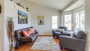 A living room with two sofas, a rug, and artwork on the walls. - 2 Master Suites with King beds fast Wifi (Centennial)