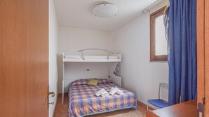 A small, compact room with a bunk bed, a desk, and a chair. - 5 bedroom beach front home in Arbus (Arbus)