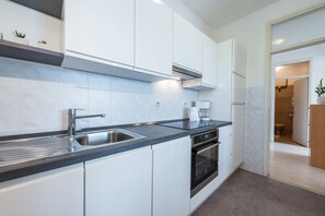 Apartment (Three-Bedroom Apartment with Balcony ) | Private kitchen | Fridge