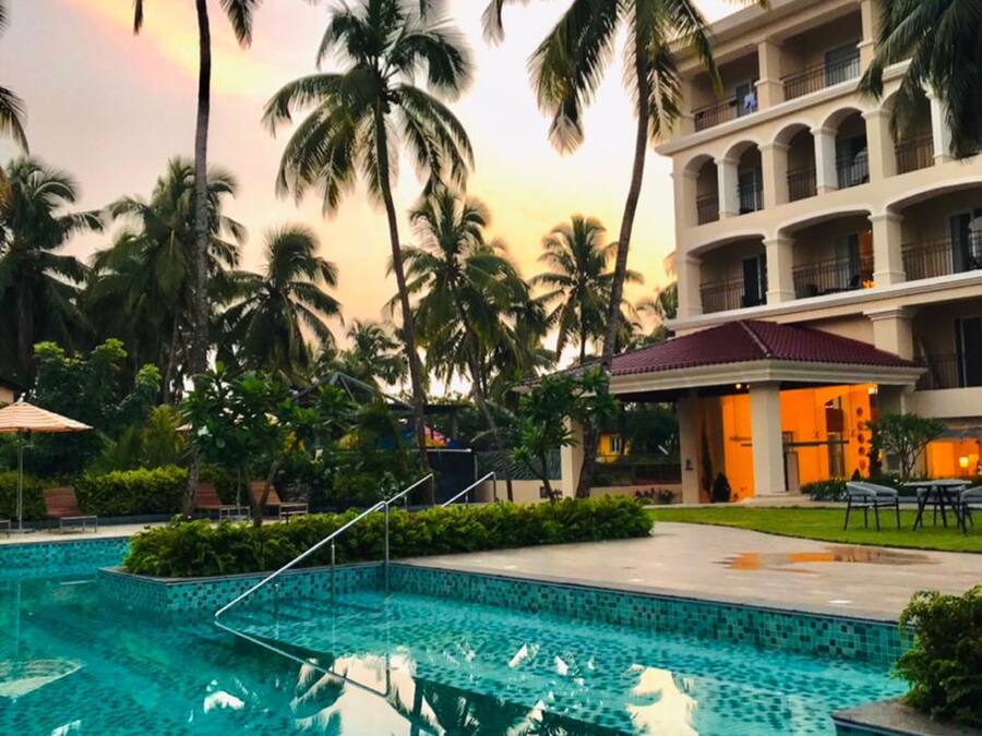 Outdoor pool, open 8:00 AM to 8:00 PM, pool umbrellas