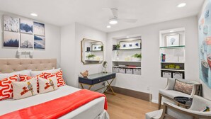 A bedroom with a bed, a desk, a chair, and shelves with decorative items. - Special VRBO Rates! - Steps to Gondola! Cozy Aspen Stay (Aspen)