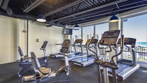 A gym with treadmills, elliptical machines, and a stationary bike.