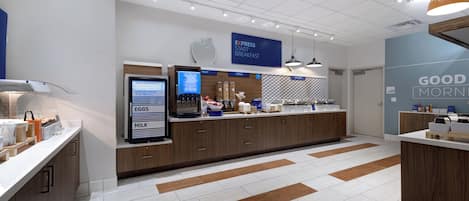 A modern breakfast area with a self-serve station, a digital menu display, and a 'Good Morning' wall.