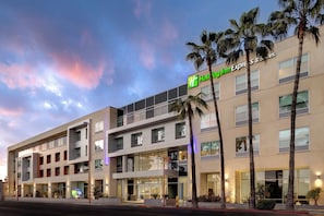 A multi-story hotel with a prominent Holiday Inn Express & Suites sign, featuring a modern architectural design with large windows and a flat roof. - Holiday Inn Express & Suites Glendale Downtown by IHG (Glendale)