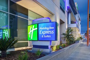 A Holiday Inn Express & Suites sign with a modern building facade and landscaped area. - Holiday Inn Express & Suites Glendale Downtown by IHG (Glendale)