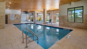 An indoor swimming pool with a wooden ceiling, clear pool area, and lounge chairs. - Holiday Inn Express St. Augustine - Vilano Beach by IHG (St. Augustine)