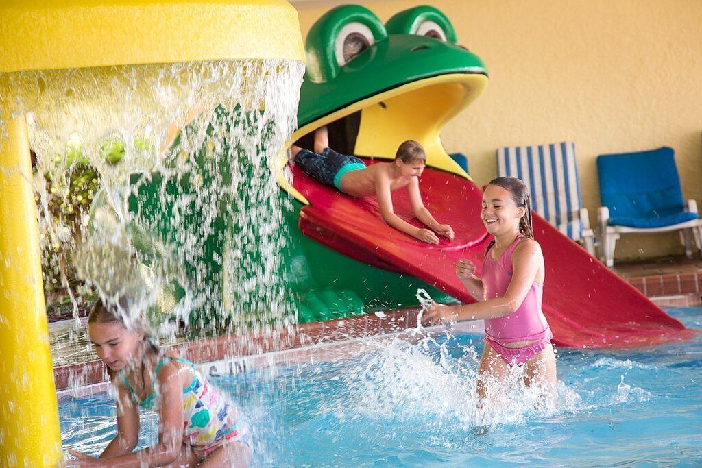 A water play area with a frog slide and a pool.