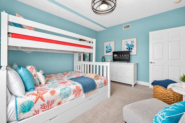 A child's bunk bed with a decorative headboard, a white dresser, and a framed sign on the wall. - Side,Ocean View-No-drive beach-Sanibel #606 (Daytona Beach Shores)