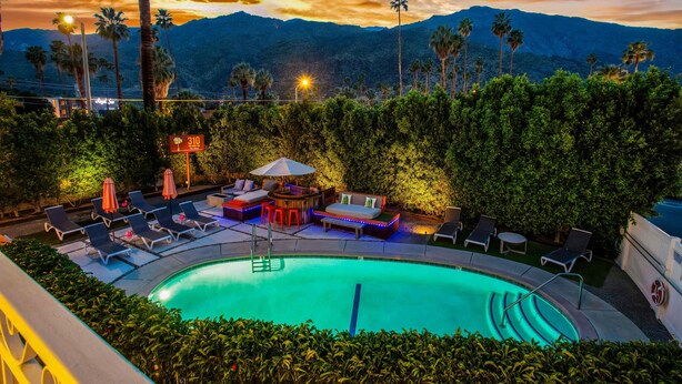 A pool area with lounge chairs, a hot tub, and a view of mountains at sunset. - EXCLUSIVE *PRIVATE* COMPOUND~ The Three Ten Hotel (Palm Springs)
