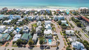 An aerial view of a coastal residential area with houses, a beach, and a hotel with a pool. - Pet-Friendly | Steps to Beach | Pool (Destin)