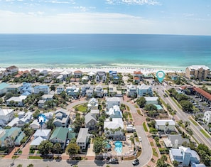 An aerial view of a coastal residential area with houses, a beach, and a hotel with a pool. - Pet-Friendly | Steps to Beach | Pool (Destin)