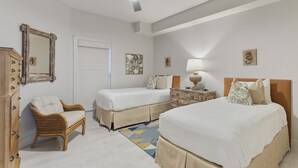 A hotel room with two beds, a chair, a dresser, a ceiling fan, and artwork on the walls. - Grand Playa, Unit 402 | Gulf - Front Condo | Priva (Santa Rosa Beach)