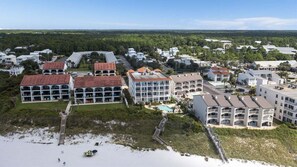 A coastal hotel with multiple buildings, a pool, and a beach access area. - Grand Playa, Unit 402 | Gulf - Front Condo | Priva (Santa Rosa Beach)