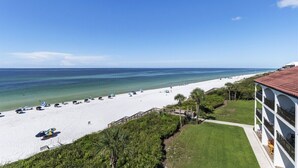 A beach with white sand, umbrellas, and a clear blue sky. - Grand Playa, Unit 402 | Gulf - Front Condo | Priva (Santa Rosa Beach)