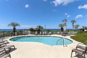 A pool area with lounge chairs, a no diving sign, and a view of the ocean. - Grand Playa, Unit 402 | Gulf - Front Condo | Priva (Santa Rosa Beach)