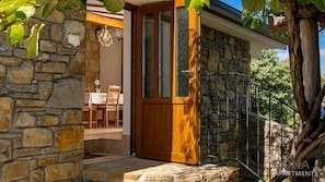 Enter a secure outdoor space with a seating area and stone wall.