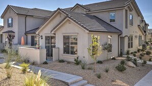 A two-story house with a sloped roof, large windows, and a landscaped garden with gravel and small plants. - Washington Townhome w/ Patio + Resort Perks! (Washington)
