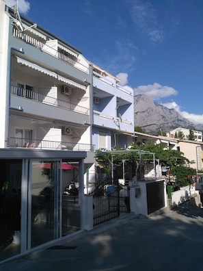 Stunning mountain views from balconies, with a modern building design and lush surroundings.
