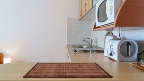 A kitchen with a microwave, toaster, and sink. - Studio With Sea View for 2-3people by the Water (Baska Voda)