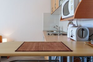 A kitchen with a microwave, toaster, and sink. - Studio With Sea View for 2-3people by the Water (Baska Voda)