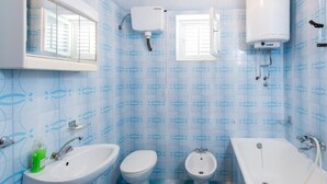 A bathroom with a sink, toilet, bidet, and bathtub. - Guest House Raguz (Dubrovnik)