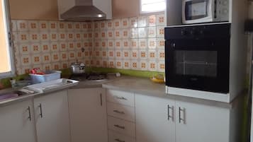 Fridge, microwave, coffee/tea maker, cookware/dishes/utensils