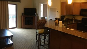 A modern kitchen with wooden cabinets, a built-in microwave, and a coffee maker. - Wyndham Great Smokies Lodge at Wilderness water park(s) included (Sevierville)