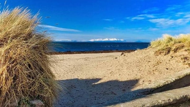 A beach with clear skies, a sandy shore, and distant mountains. - Marina View, Lovely Upper 3 Bedroom Apartment (Troon)