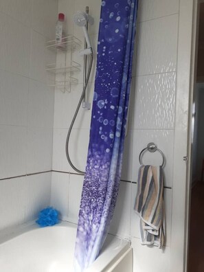 A bathroom with a shower, a towel rack, and a blue bath mat. - Marina View, Lovely Upper 3 Bedroom Apartment (Troon)