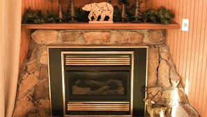 A stone fireplace with a television mounted above it. - Private & Secluded w/ Beautiful Views Sunsets ~Hot Tub (Gatlinburg)