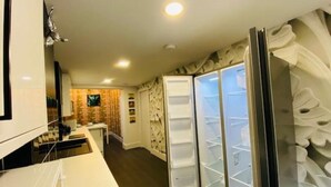 A compact kitchen with a refrigerator, a microwave, and a sink. - Townhouse Plus @ Lower Beth Street Stoke (Stoke-on-Trent)