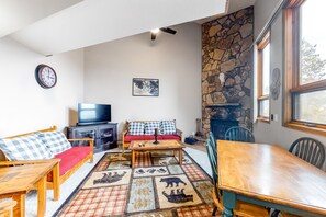 TV, fireplace, books - Lofty condo with beautiful mountain & lake views plus wood fireplace (Silverthorne)