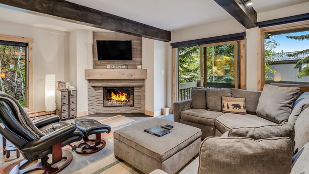 A modern living room with a fireplace, leather recliner, sectional sofa, and large windows. - 🏔️Ski-in, Ski-out Condo~Hot Tub~Interlude 101🏔️ (Snowmass Village)