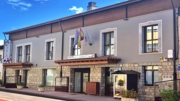 A building with a sign that reads "OPEN SANTA." - Pena Santa Hotel (Onis)