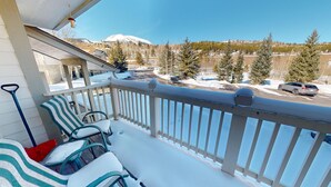 A balcony with a view of a snowy landscape, including a mountain and trees. - Walk to Lake Rec Path! Corner Unit Close to Everything! 2 Hot Tubs (Frisco)