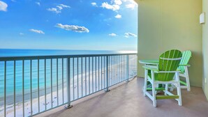 A balcony with a view of the beach and ocean. There are two green Adirondack chairs and a small table. - Escapes to the Shores 1702 by Liquid Life (Orange Beach)