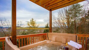 Un bain à remous avec une terrasse en bois et une vue magnifique.